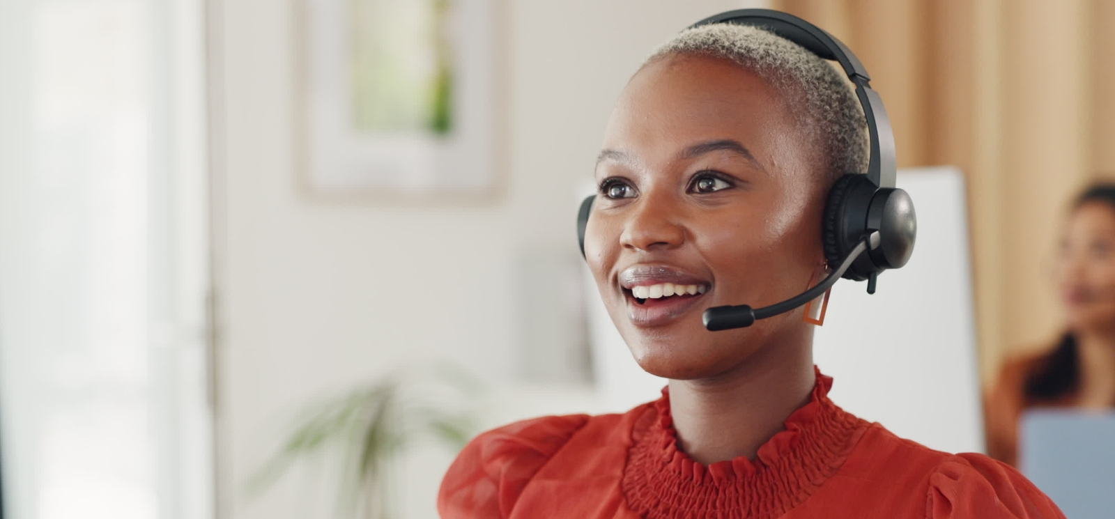 Woman with a headset using a VoIP phone system
