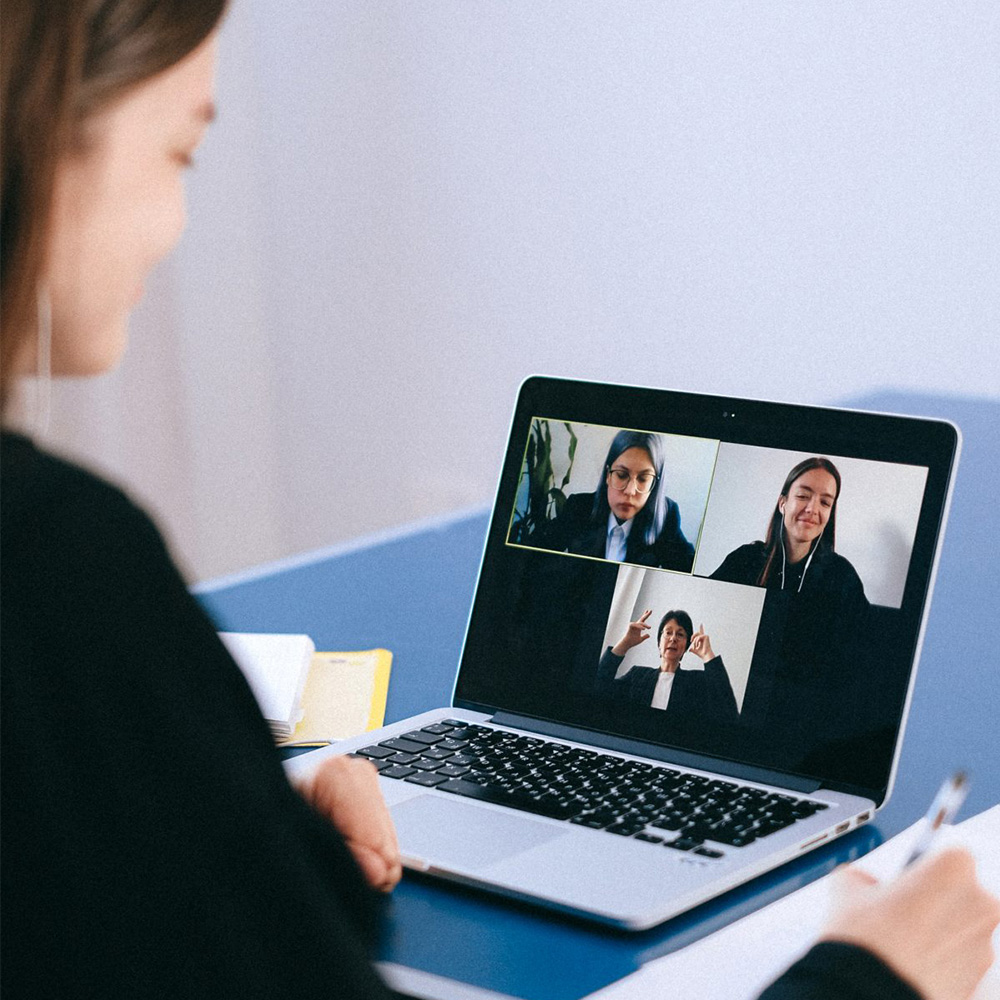 Woman virtually conferencing with her colleagues